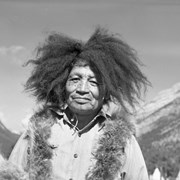 Cover image of Hansen Bearspaw (Ade Ejiyabin), "Banff Indian Days clown" wearing buffalo mane wig, always making jokes and songs